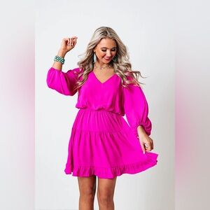A bright fuchsia, flowy & mid-thigh length dress from Shop Impressions Boutique.